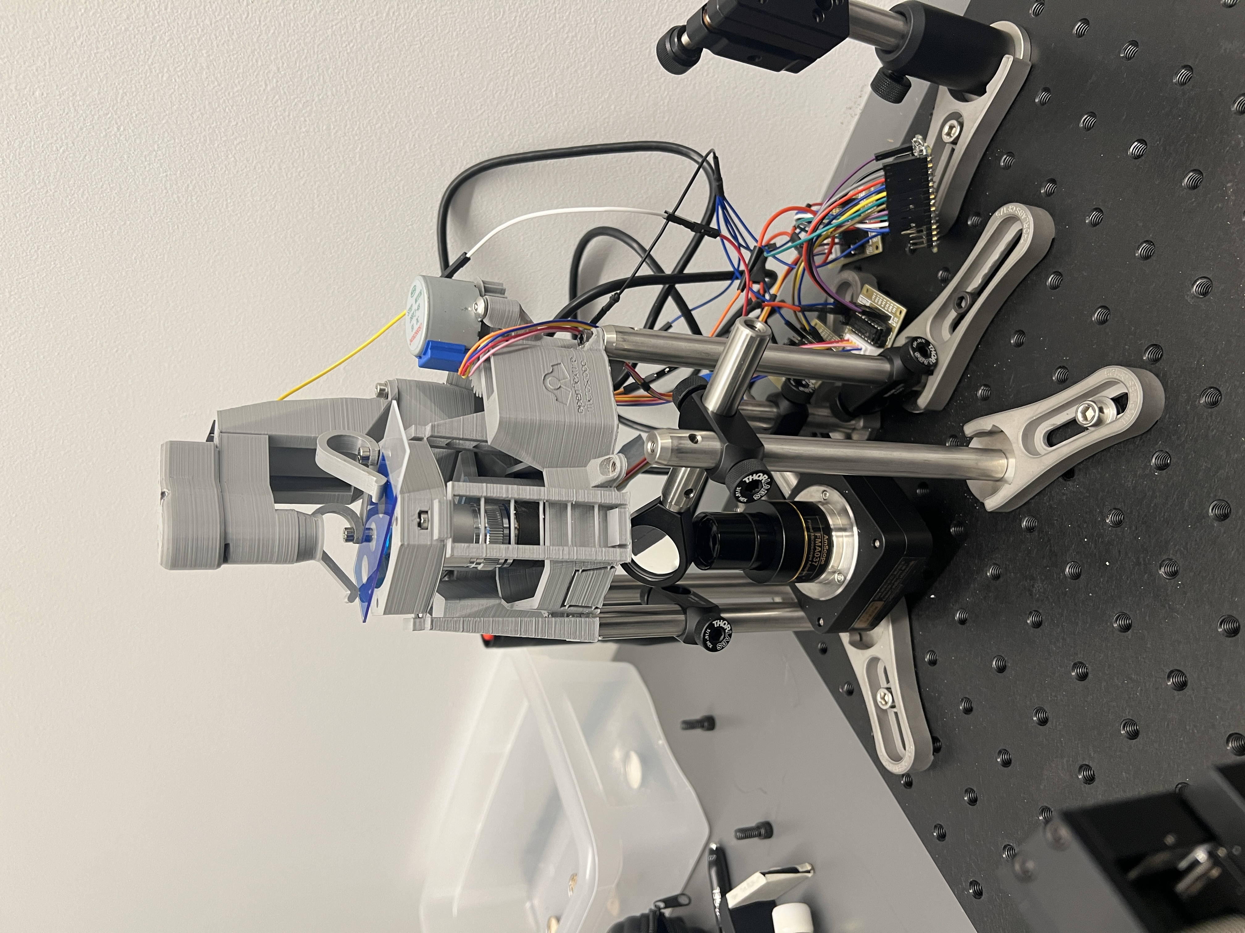 Wide view of the optical tweezer setup on the lab bench